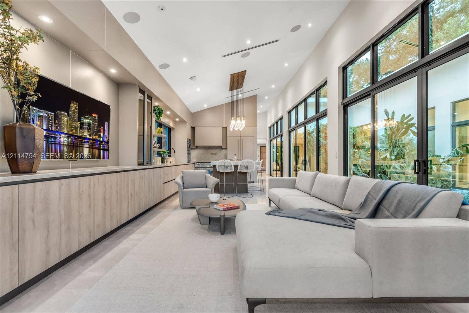 6731 SW 64th Avenue, South Miami, FL 33143 Vaulted ceilings, expansive glass sliding doors, built-in floor-to-ceiling cabinetry, recessed lighting, and large-format tile flooring