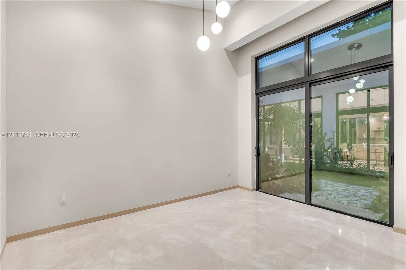 6731 SW 64th Avenue, South Miami, FL 33143 Vaulted ceilings with recessed lighting, stone-finish flooring, and minimalist wood-finish interior doors