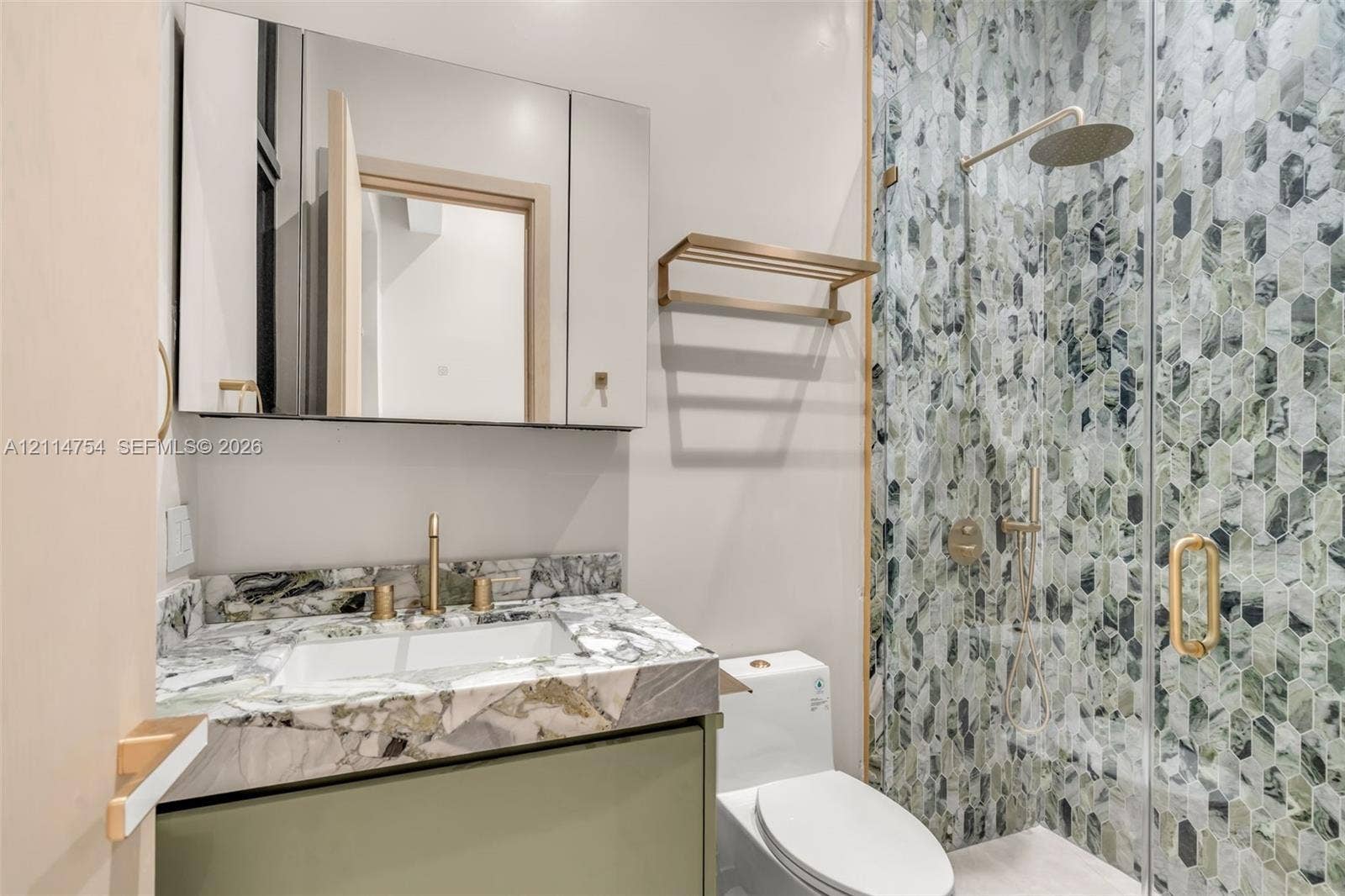 6731 SW 64th Avenue, South Miami, FL 33143 Custom wood-finish cabinetry featuring integrated vertical and recessed LED lighting, multi-level open shelving, and matte black hanging rods