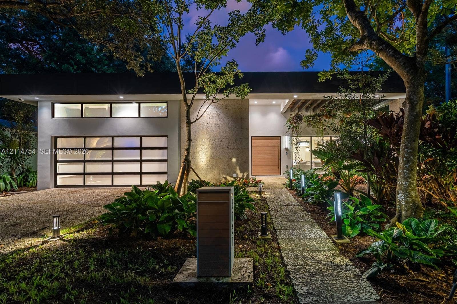 6731 SW 64th Avenue, South Miami, FL 33143 Aerial perspective featuring a rectangular swimming pool with hardscaped surround, integrated central garden courtyard, and standing seam metal roofing
