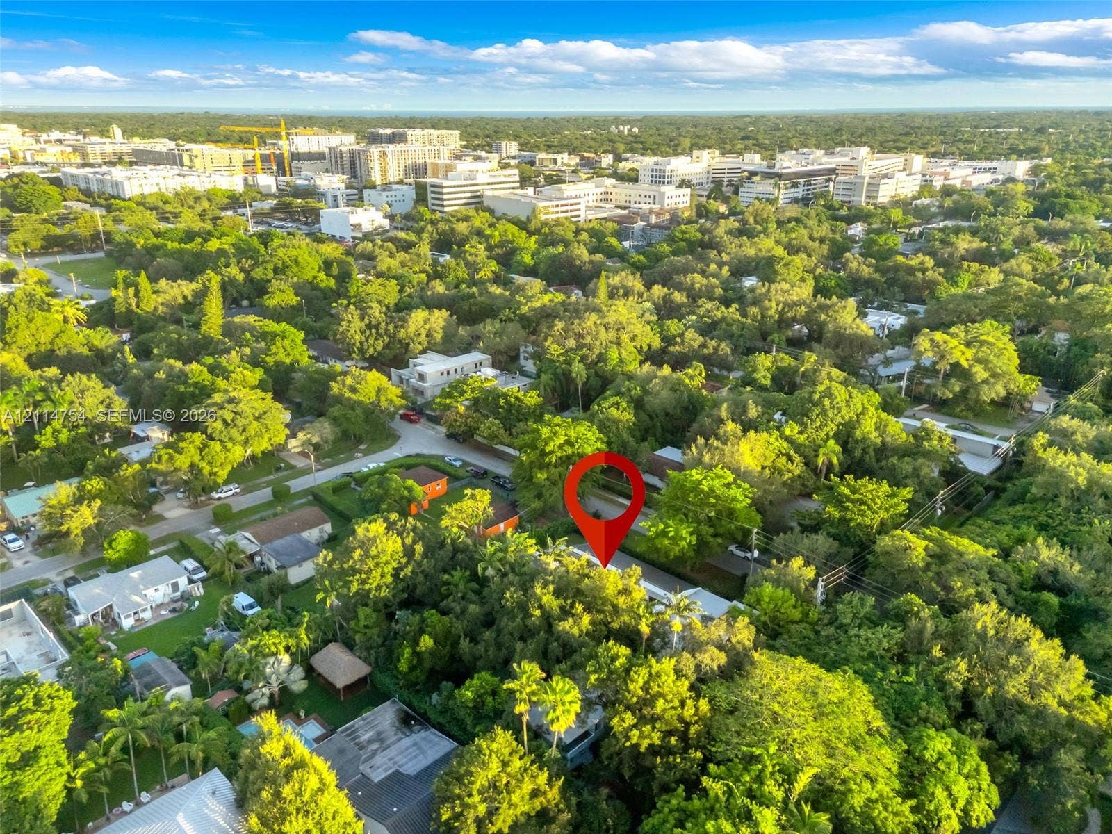 6731 SW 64th Avenue, South Miami, FL 33143 Aerial perspective of residential property featuring a swimming pool, mature tree canopy, and dense surrounding vegetation