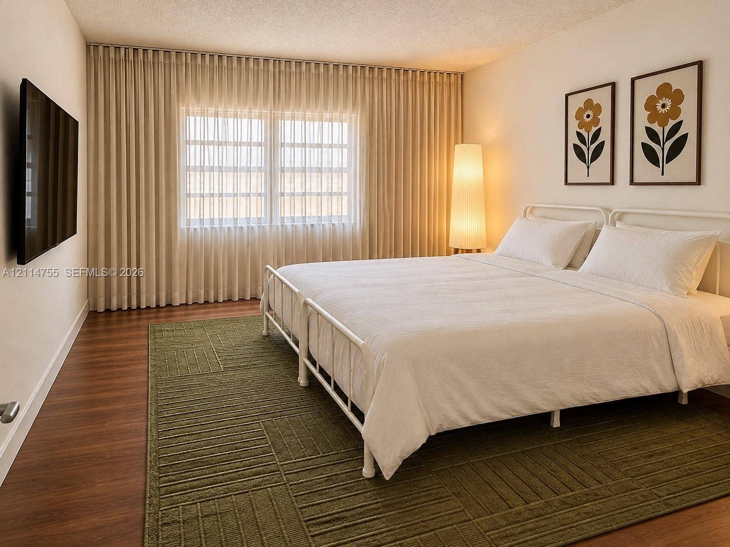 231 174th Street, #MO-3, Sunny Isles Beach, FL 33160 Wood-finish flooring, full-wall drapery, and a wall-mounted television