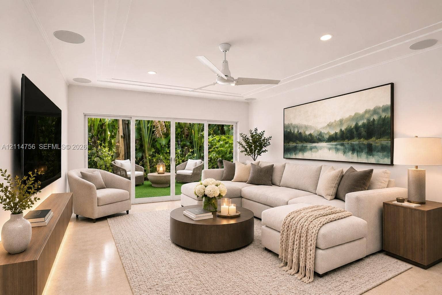 Living space featuring recessed lighting, a ceiling fan, crown molding, integrated ceiling speakers, and multi-panel sliding glass doors