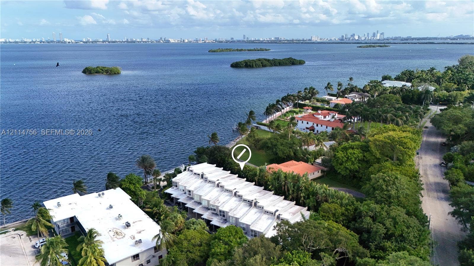Waterfront townhome community featuring multi-level architecture, flat rooflines, and expansive shoreline access