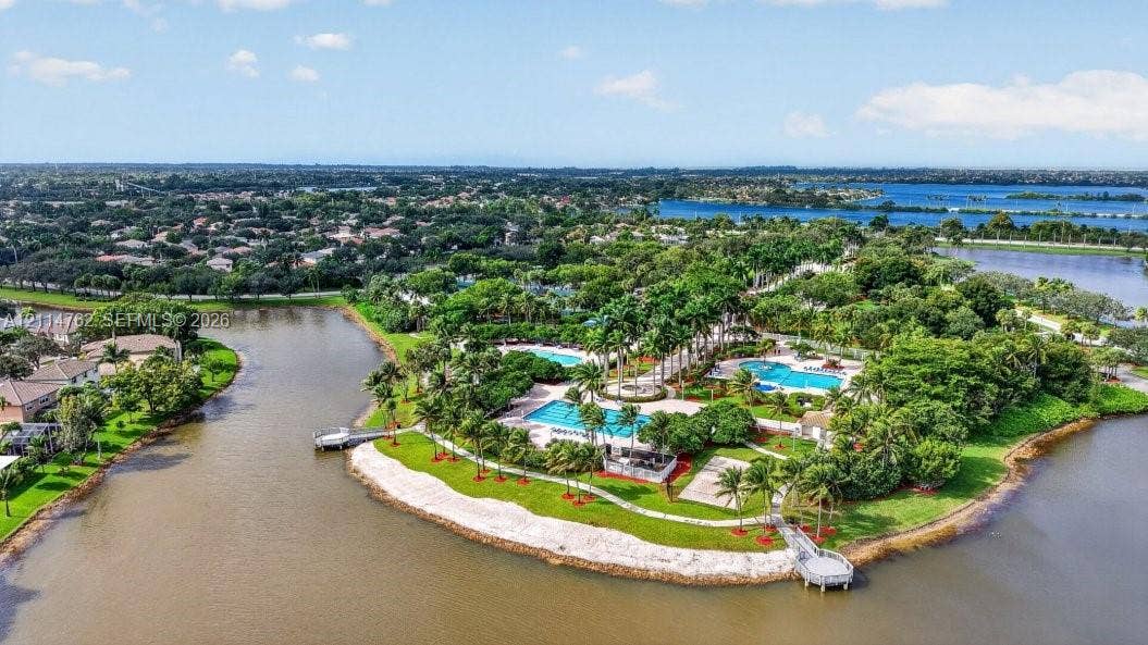 662 NW 170th Terrace, Pembroke Pines, FL 33028 Waterfront community amenities featuring multiple swimming pools, paved walking paths, mature landscaping, and private boat docks