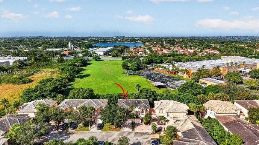 662 NW 170th Terrace, Pembroke Pines, FL 33028 Aerial perspective featuring a multi-story residence with a pitched tile roof, attached multi-car garage, and direct proximity to expansive green space