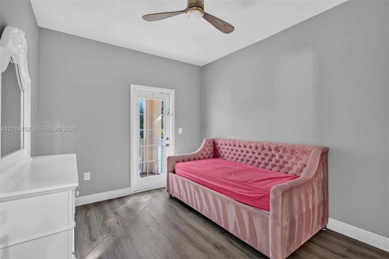 662 NW 170th Terrace, Pembroke Pines, FL 33028 Neutral-toned interior featuring wood-finish flooring, a contemporary ceiling fan, and a glass-paneled exterior door