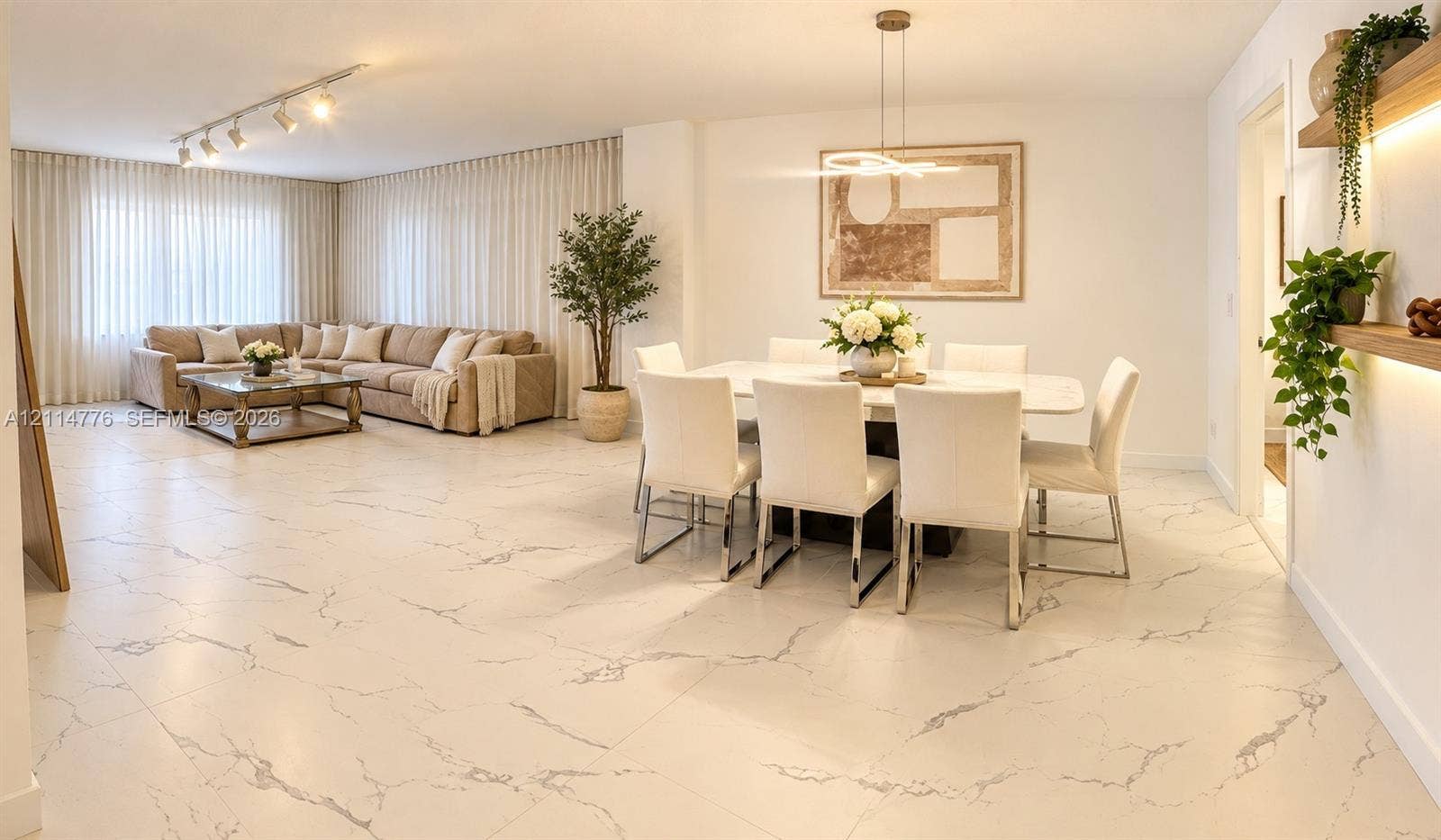 Large-format stone-finish tile flooring, recessed track lighting, modern pendant chandelier, and built-in wall shelving with integrated LED illumination