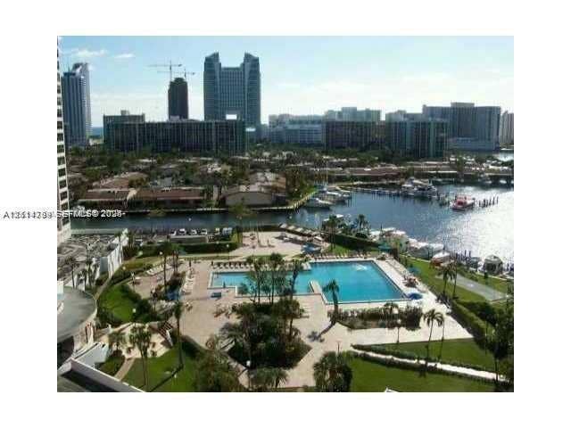 2500 Parkview Drive, #811, Hallandale Beach, Hallandale Beach, FL 33009 Aerial perspective featuring a waterfront swimming pool, paved pool deck, manicured green space, and maritime slips