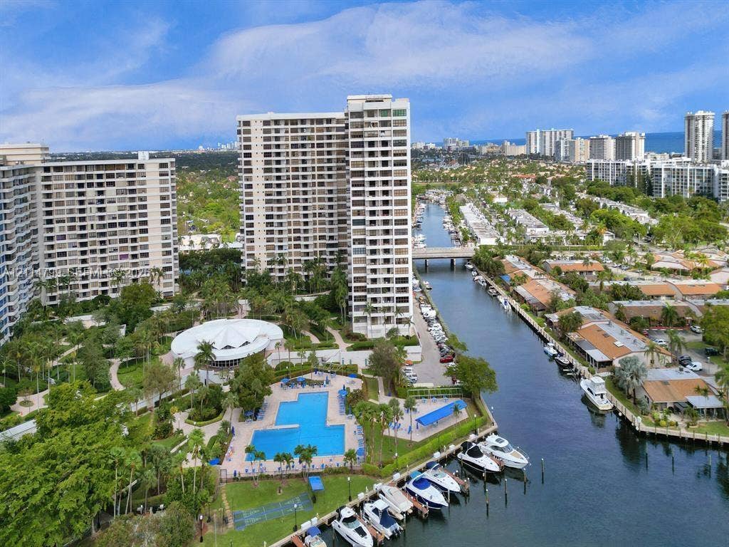 2500 Parkview Drive, #811, Hallandale Beach, Hallandale Beach, FL 33009 Aerial perspective of high-rise residential complex featuring a community swimming pool, canal-front boat slips, and landscaped grounds