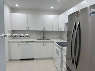 2500 Parkview Drive, #811, Hallandale Beach, Hallandale Beach, FL 33009 Kitchen featuring white flat-panel cabinetry, stone-finish countertops, stainless steel refrigerator, recessed lighting, and tile flooring