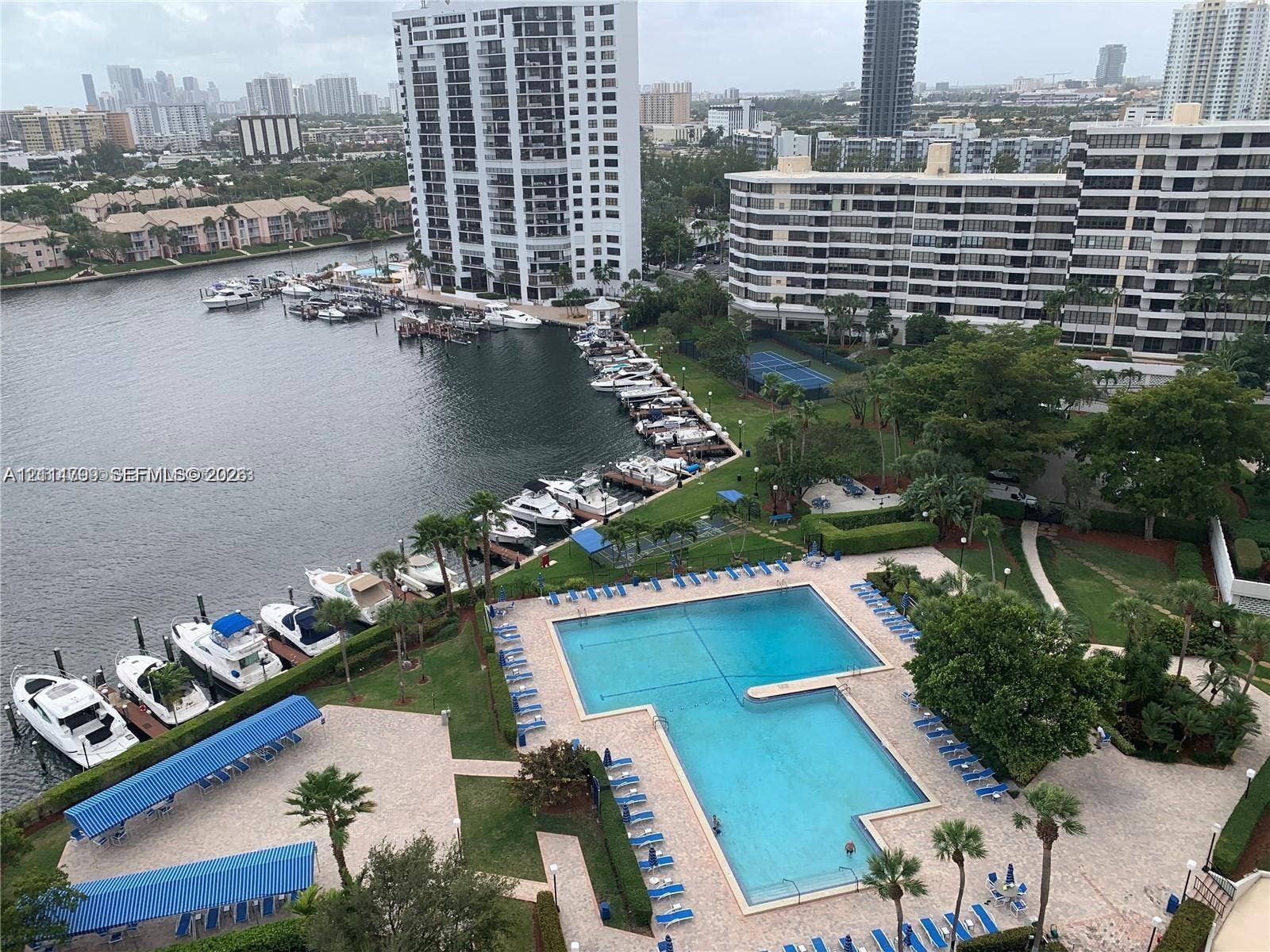 2500 Parkview Drive, #811, Hallandale Beach, Hallandale Beach, FL 33009 Waterfront community featuring an expansive swimming pool with hardscaped sundeck, dedicated boat slips, and mature landscaping