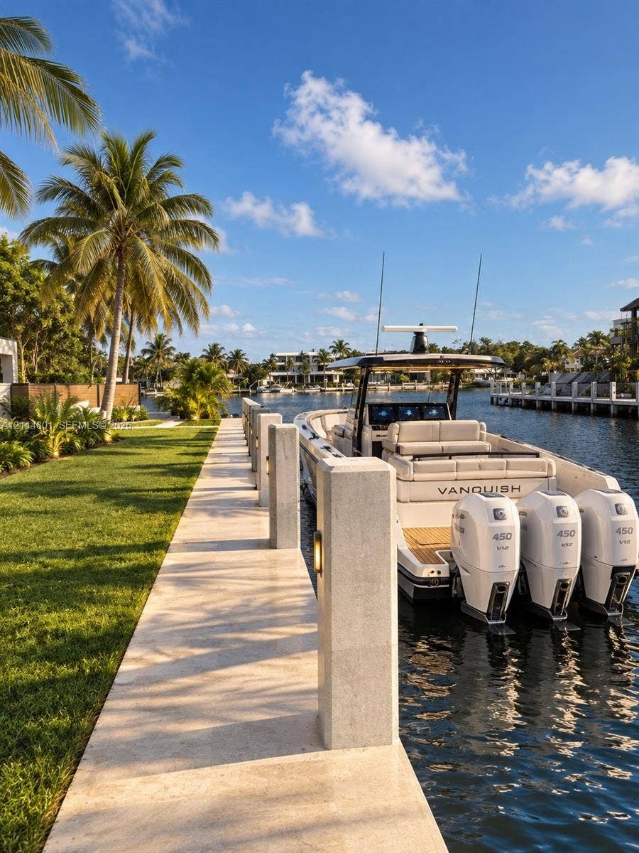 2218 NE 16th Street, Fort Lauderdale, FL 33304 Deep-water dock featuring stone pavers, integrated post lighting, and mature palms