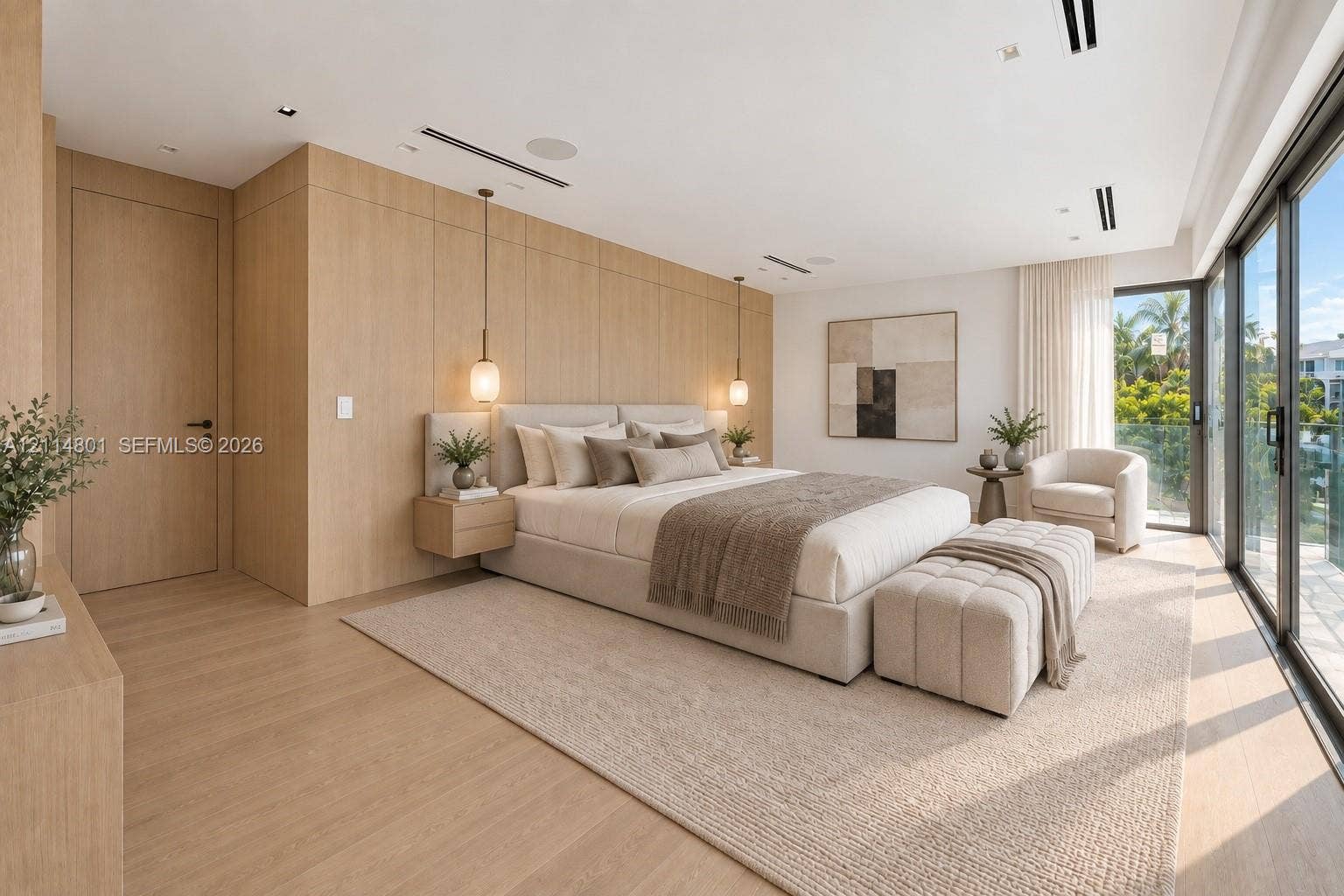 2218 NE 16th Street, Fort Lauderdale, FL 33304 Floor-to-ceiling wood-finish paneling, custom wall-mounted nightstands, recessed linear ceiling lighting, integrated audio speakers, and floor-to-ceiling glass sliding doors