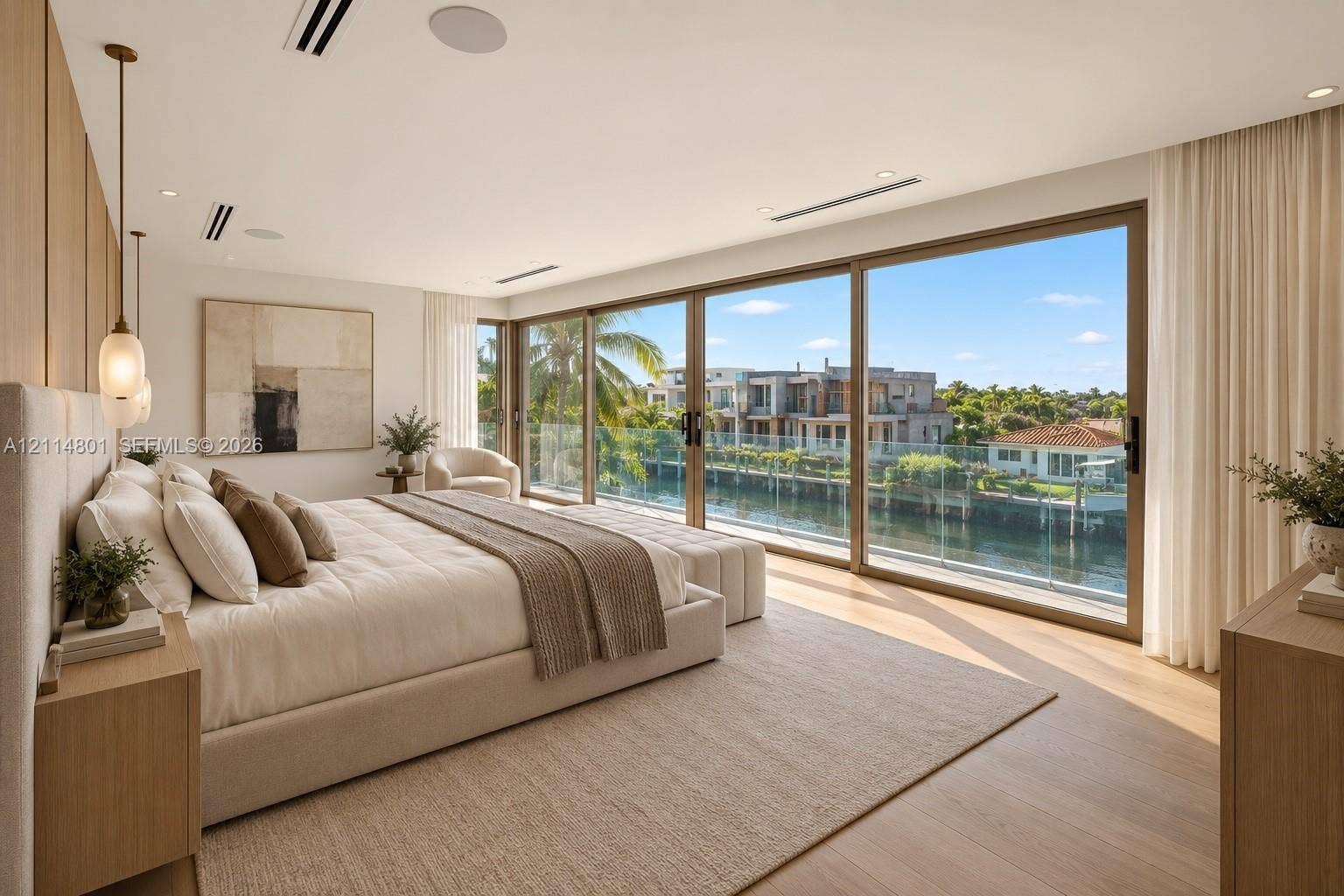 2218 NE 16th Street, Fort Lauderdale, FL 33304 Floor-to-ceiling sliding glass walls, wood-finish flooring, recessed ceiling lighting, built-in wooden accent wall paneling, and glass-railed exterior balcony