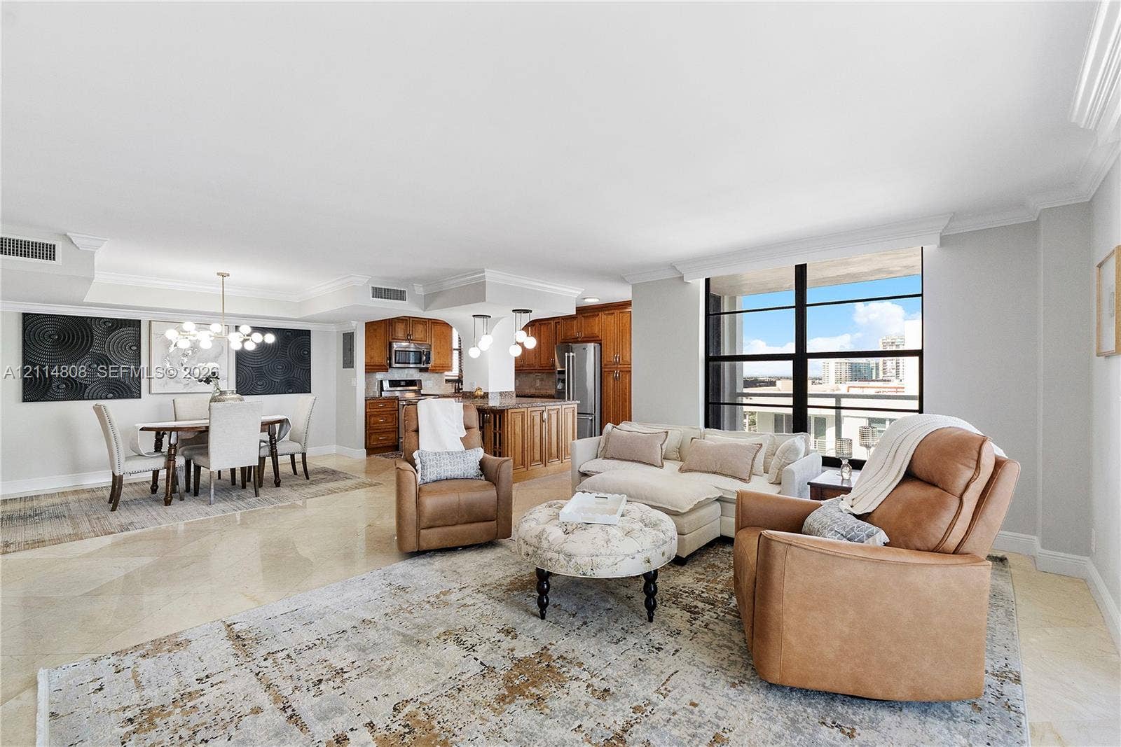 1000 S Ocean Boulevard, #16P, Pompano Beach, Pompano Beach, FL 33062 Open-concept living space featuring stone flooring, floor-to-ceiling windows, crown molding, built-in cabinetry, and integrated multi-pendant lighting