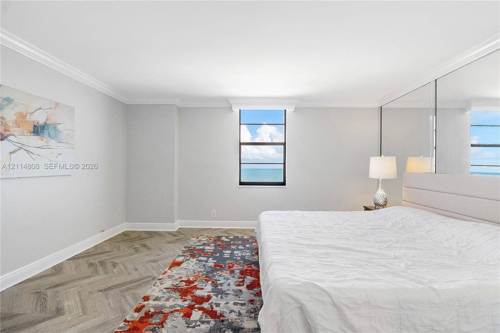 1000 S Ocean Boulevard, #16P, Pompano Beach, Pompano Beach, FL 33062 Herringbone wood-finish flooring, ceiling crown molding, floor-to-ceiling mirrored wall, and ocean horizon backdrop