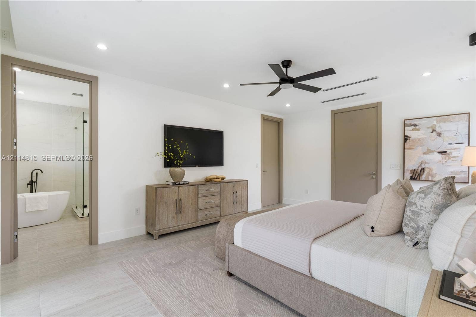 Neutral-toned room featuring a matte black ceiling fan, recessed lighting, and large-format tile flooring