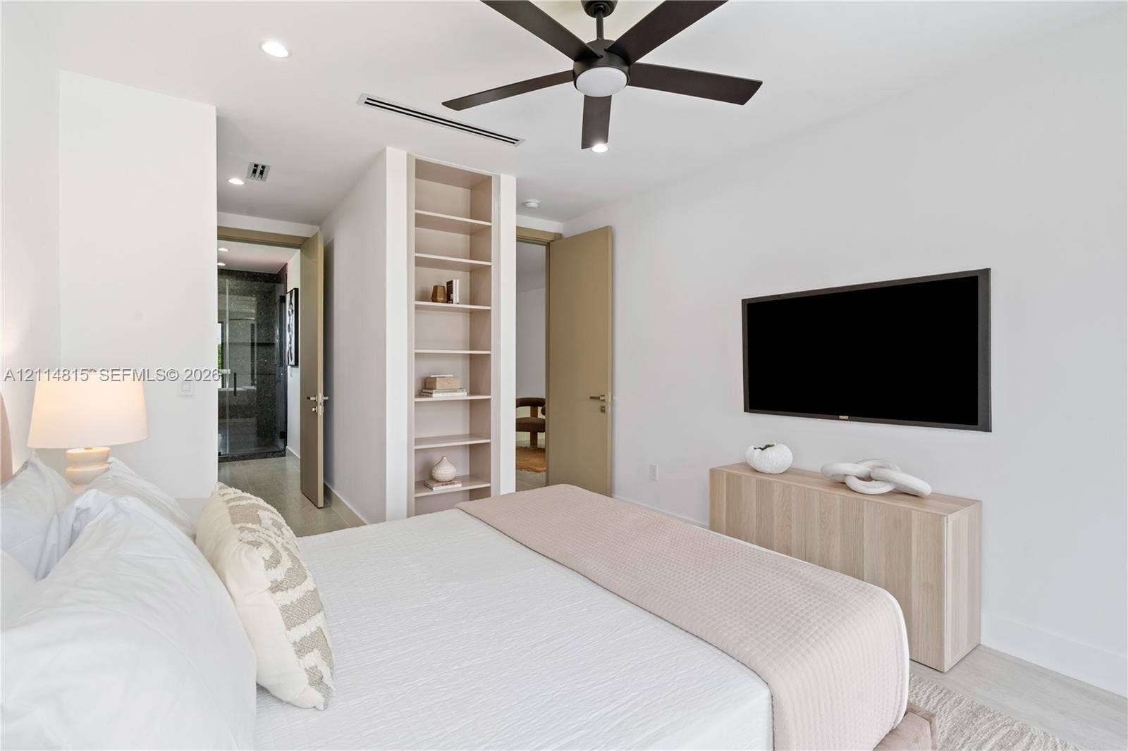 Built-in open shelving, contemporary ceiling fan, recessed lighting, and neutral wall tones