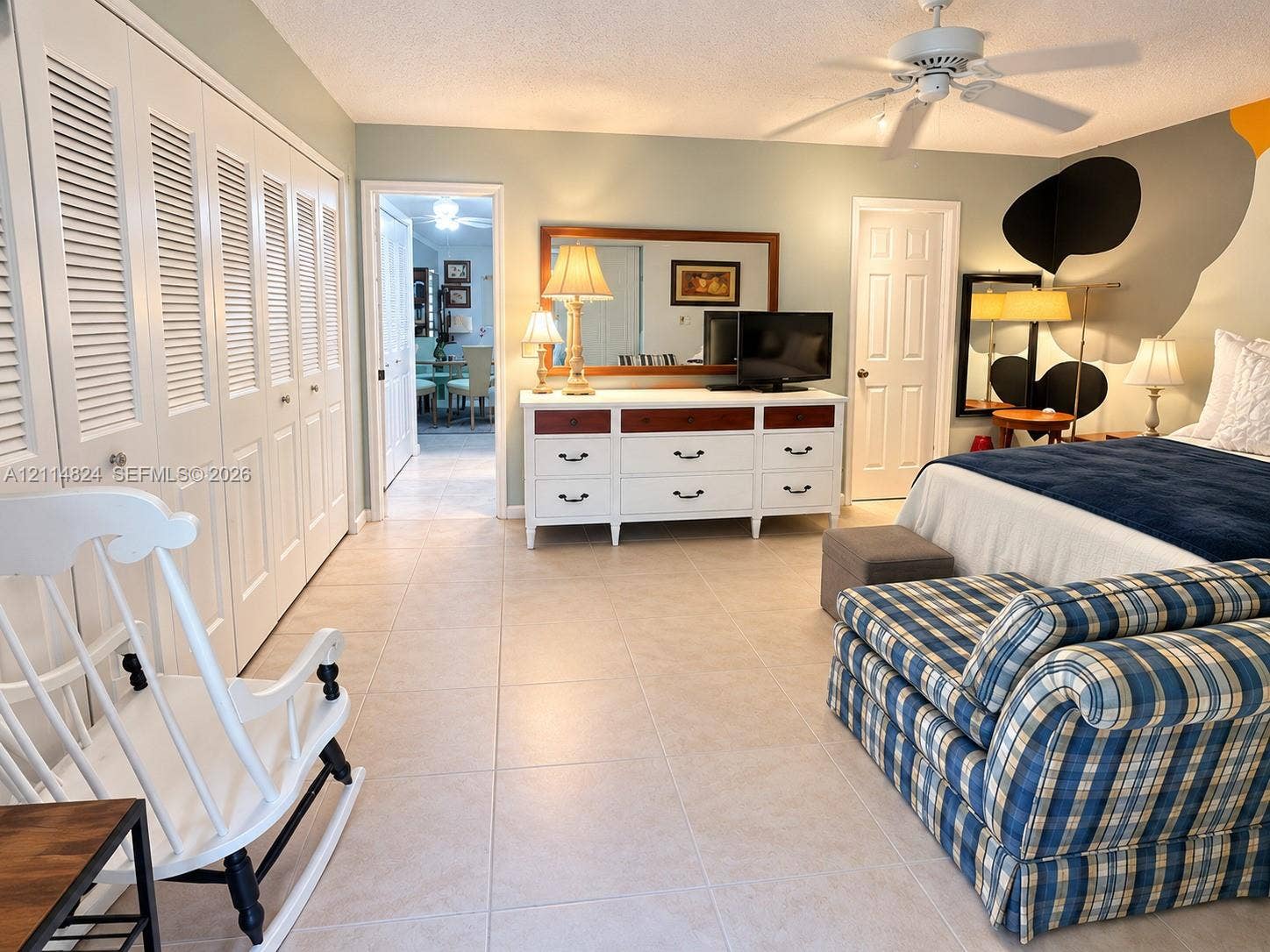 563 Durham T, #563, Deerfield Beach, FL 33442 Large room featuring neutral tile flooring, louvered closet doors, and a ceiling fan with integrated lighting