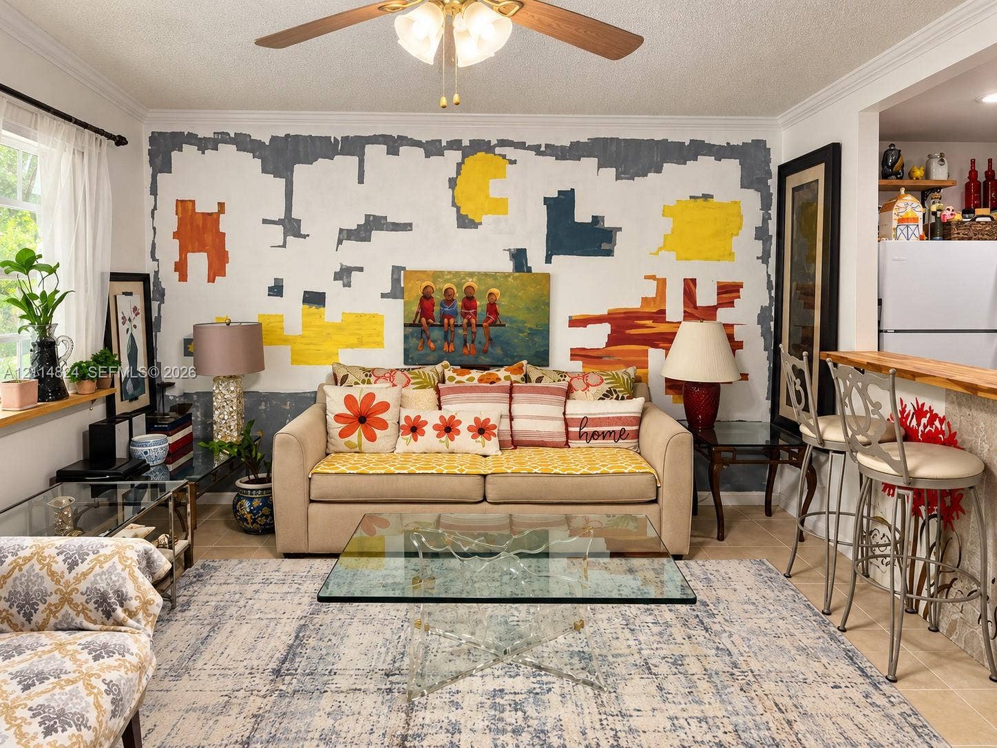 563 Durham T, #563, Deerfield Beach, FL 33442 Neutral tile flooring, breakfast bar with a wood-finish countertop, and a ceiling-mounted light fixture with a fan