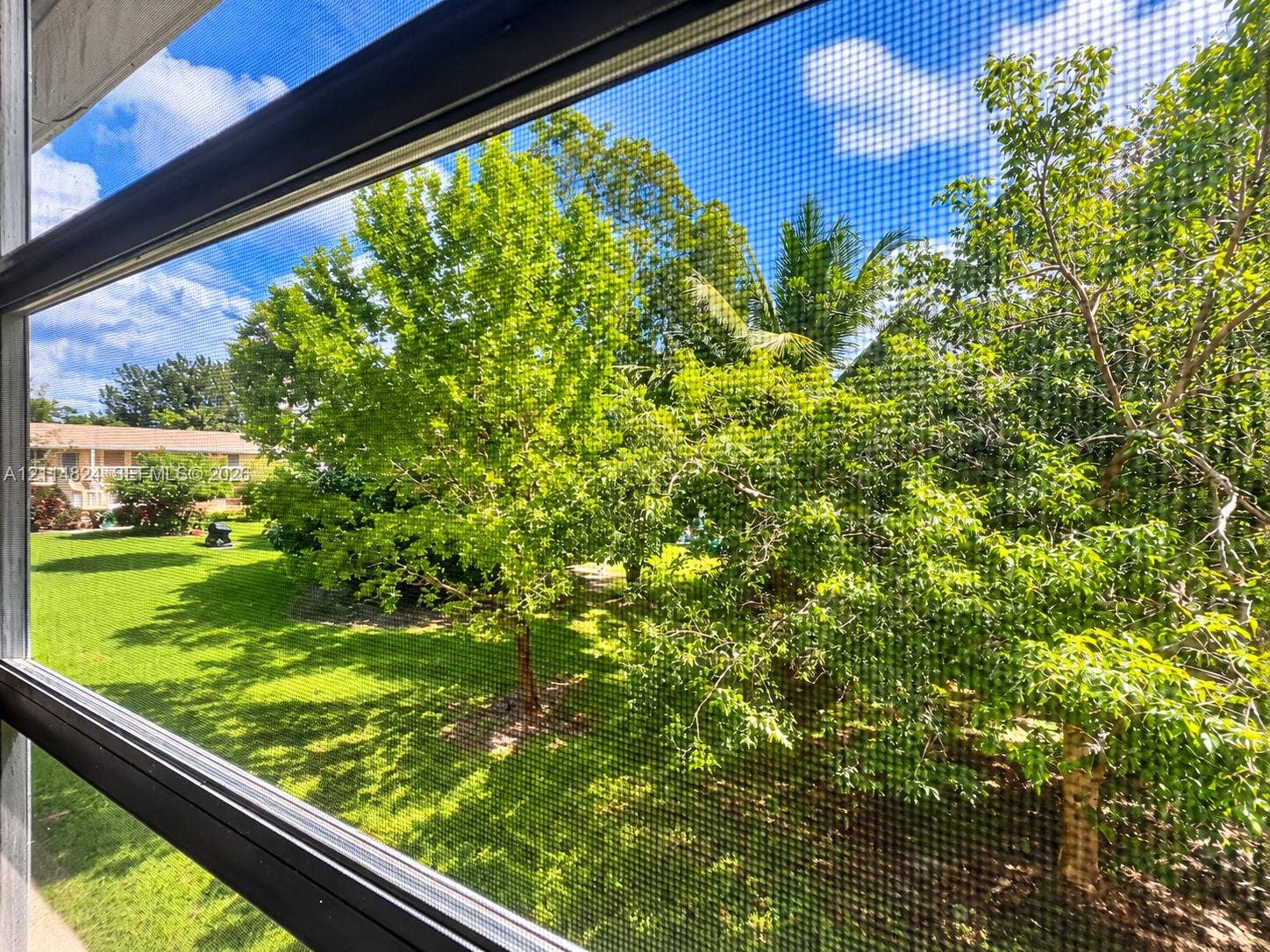 563 Durham T, #563, Deerfield Beach, FL 33442 Screened enclosure featuring an expanse of lawn and mature trees