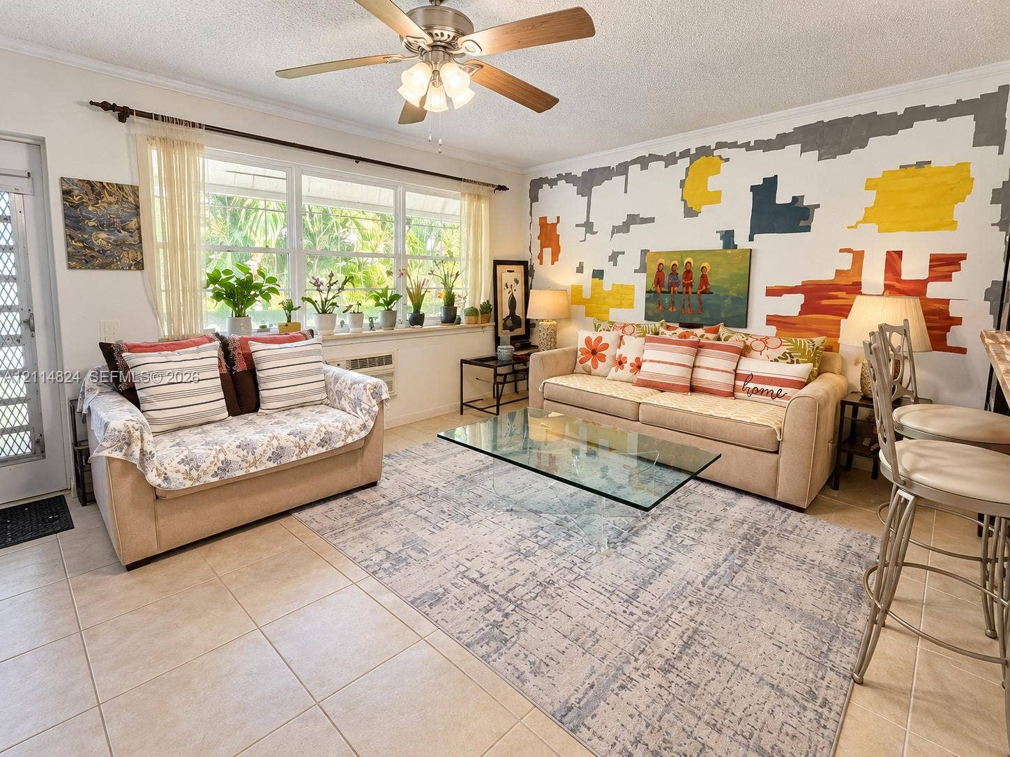 563 Durham T, #563, Deerfield Beach, FL 33442 Living area featuring large windows with natural light, neutral ceramic tile flooring, and a ceiling fan with integrated lighting