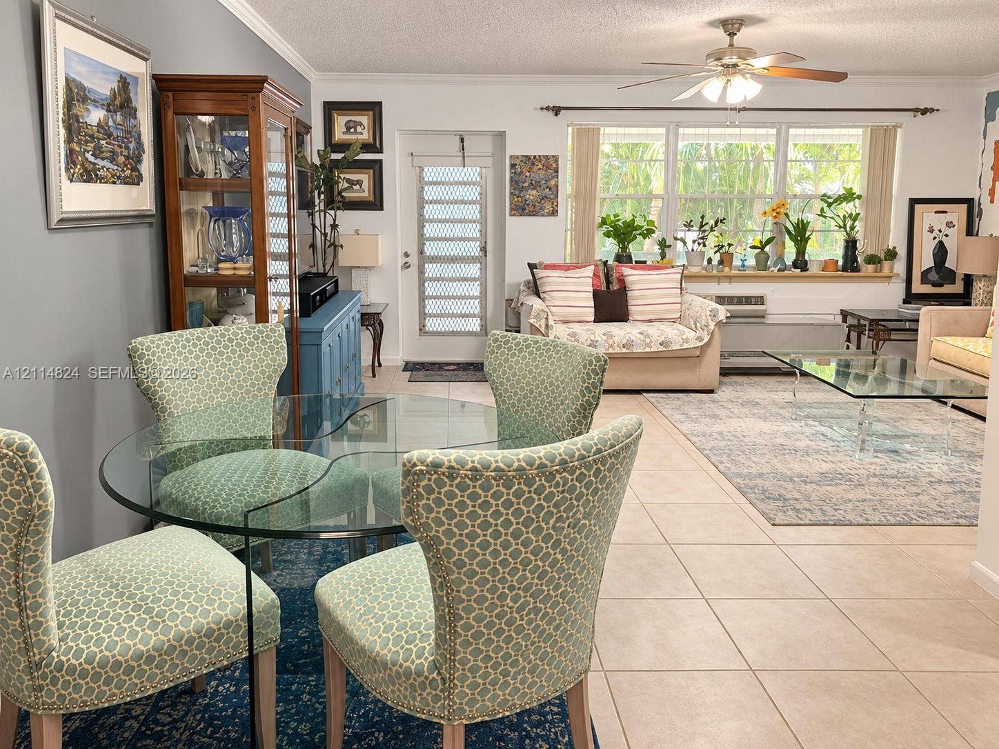 563 Durham T, #563, Deerfield Beach, FL 33442 Living area featuring large format tile flooring, crown molding, a central ceiling fan, and extensive windows