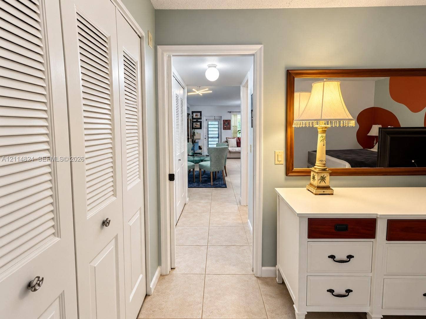 563 Durham T, #563, Deerfield Beach, FL 33442 Hallway featuring neutral-toned floor tile and white louvered-panel closets