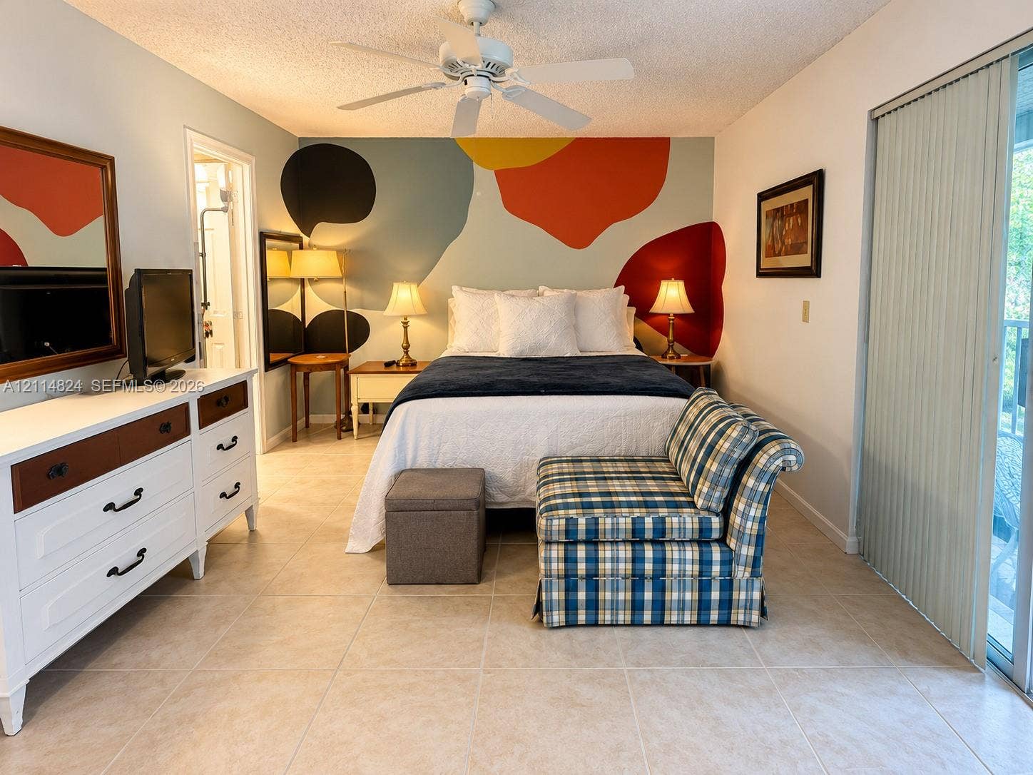 563 Durham T, #563, Deerfield Beach, FL 33442 Room featuring neutral tile flooring, a white ceiling fan, and sliding glass doors with vertical blinds