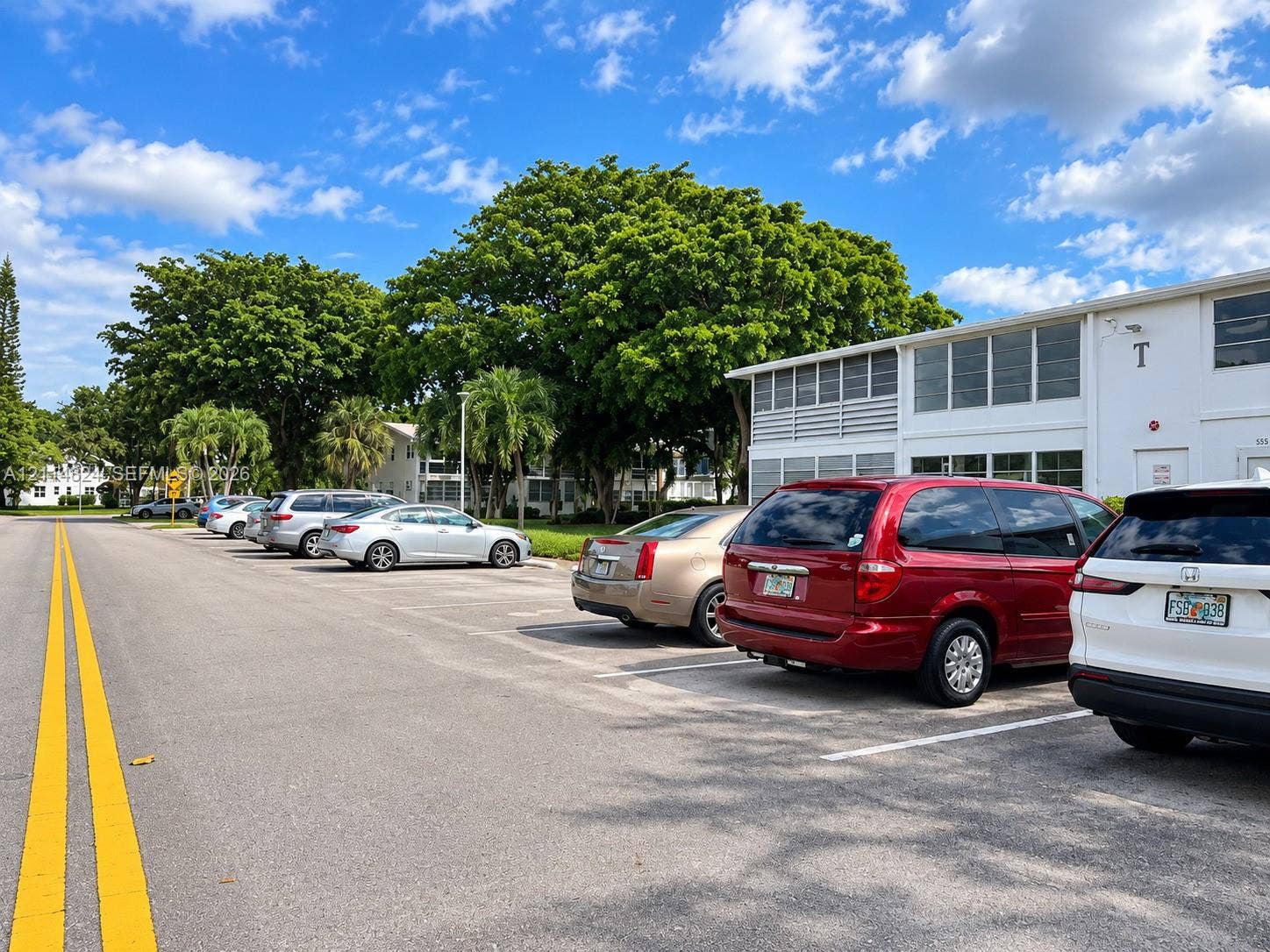 563 Durham T, #563, Deerfield Beach, FL 33442 Surface parking lot featuring designated stalls and mature trees