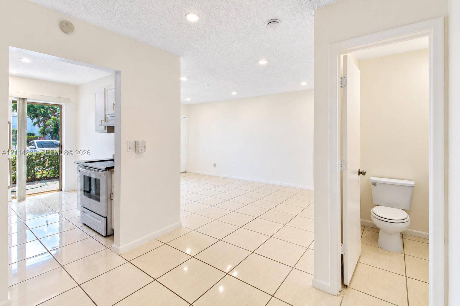 3000 NW 5th Terrace, #131, Pompano Beach, Pompano Beach, FL 33064 Neutral-toned ceramic tile flooring throughout, recessed lighting, and a compact bathroom featuring a standard porcelain toilet