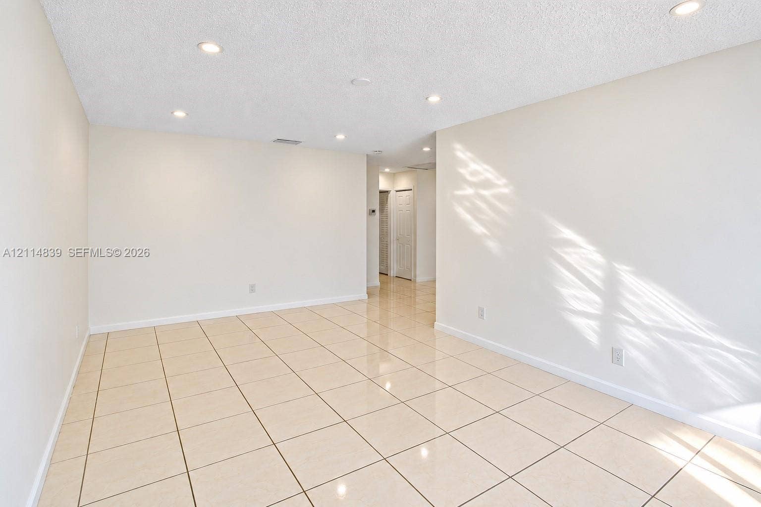 3000 NW 5th Terrace, #131, Pompano Beach, Pompano Beach, FL 33064 Neutral interior space featuring polished tile flooring, recessed lighting, and crisp, white-painted walls