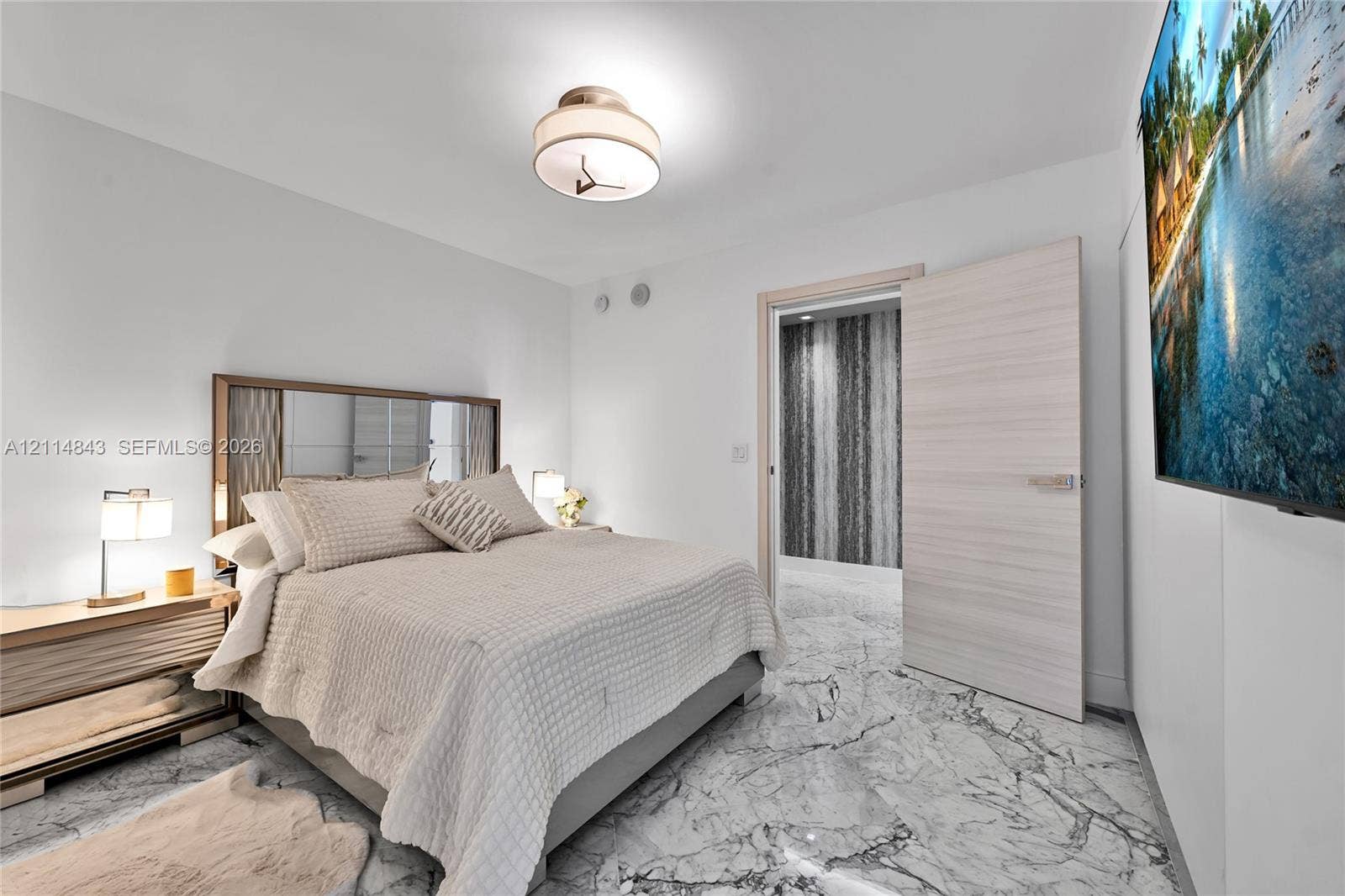 Stone-finish flooring, flush-mount lighting, and solid-core interior door with metallic hardware