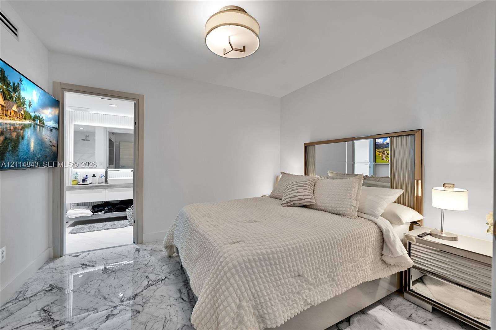 Polished stone flooring, recessed lighting, flush-mount drum fixture, and built-in mirror panel