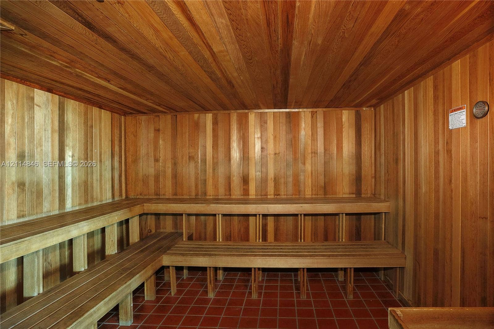 2101 Brickell Avenue, #601, Miami, Miami, FL 33129 Sauna featuring tongue-and-groove wood paneling, multi-level built-in wood bench seating, and ceramic tile flooring