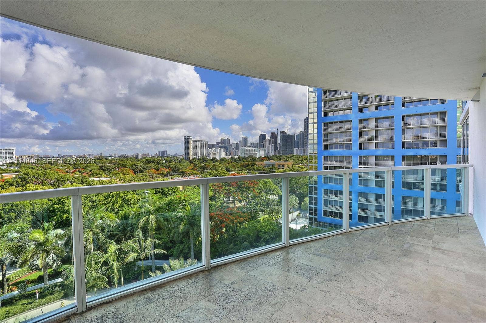 2101 Brickell Avenue, #601, Miami, Miami, FL 33129 Covered balcony featuring stone tile flooring and a glass railing