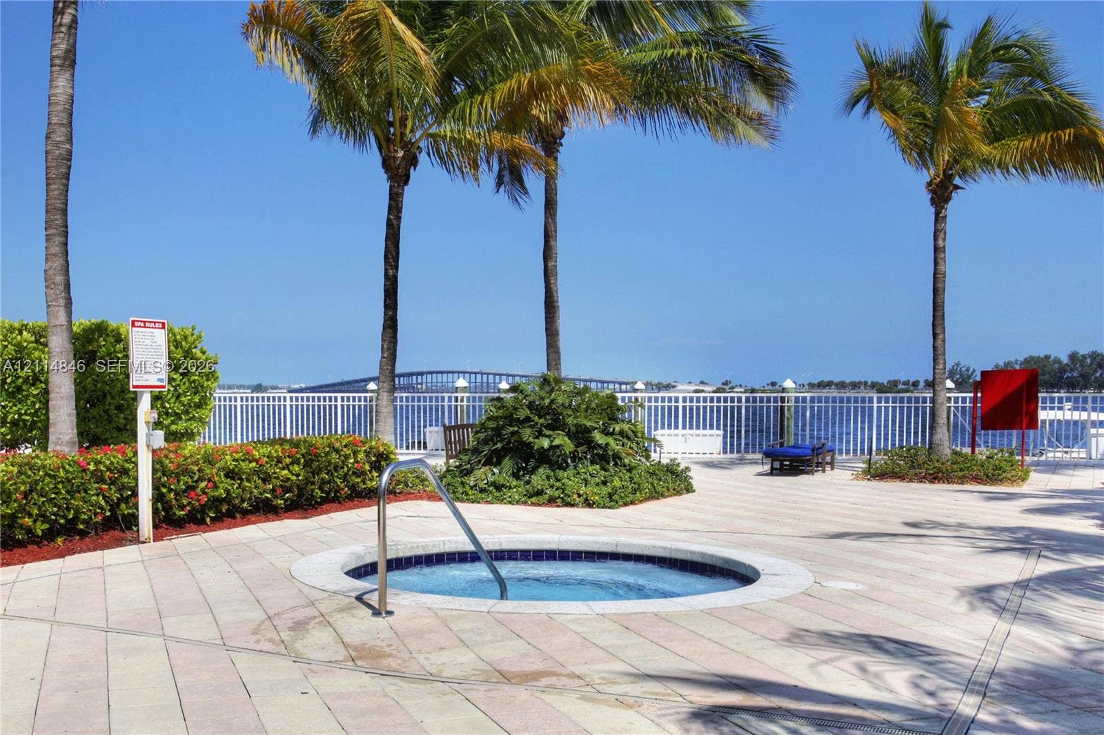 2101 Brickell Avenue, #601, Miami, Miami, FL 33129 In-ground spa with stone-paver surround, metal safety railing, and mature palm trees