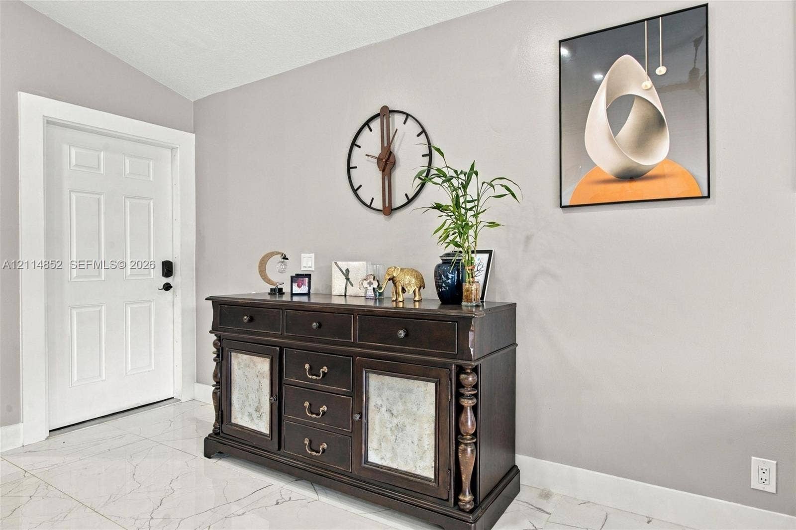 10780 NW 10th Street, Plantation, FL 33322 Entryway featuring white six-panel door and large-format polished tile flooring with veining