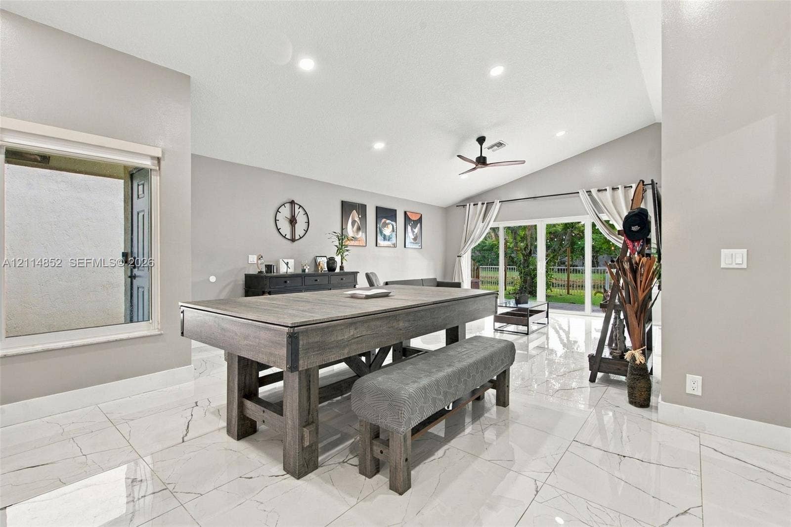 10780 NW 10th Street, Plantation, FL 33322 High-gloss, large-format tile flooring, vaulted ceilings, recessed lighting, ceiling fan, and multi-panel sliding glass doors