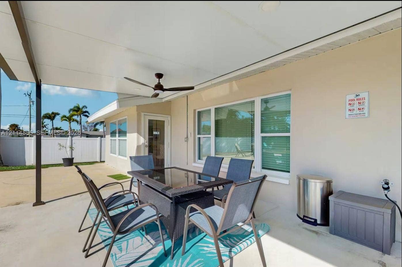 802 Montclair Court, Cape Coral, FL 33904 Covered concrete patio featuring a ceiling-mounted fan and exterior privacy fencing