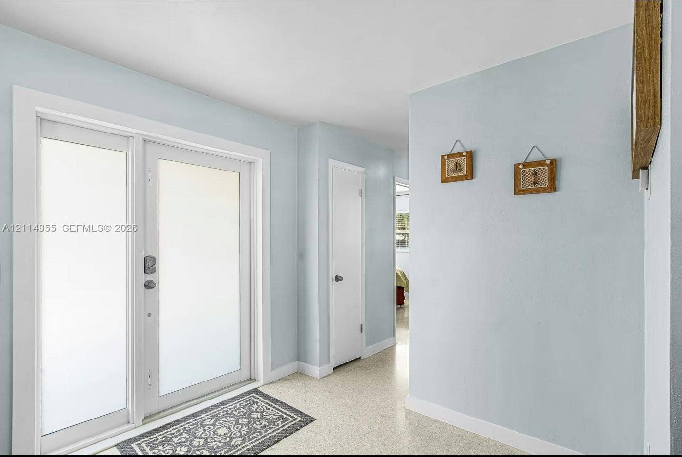 802 Montclair Court, Cape Coral, FL 33904 Double-entry door featuring frosted glass panels and neutral-toned interior walls with smooth-finish flooring