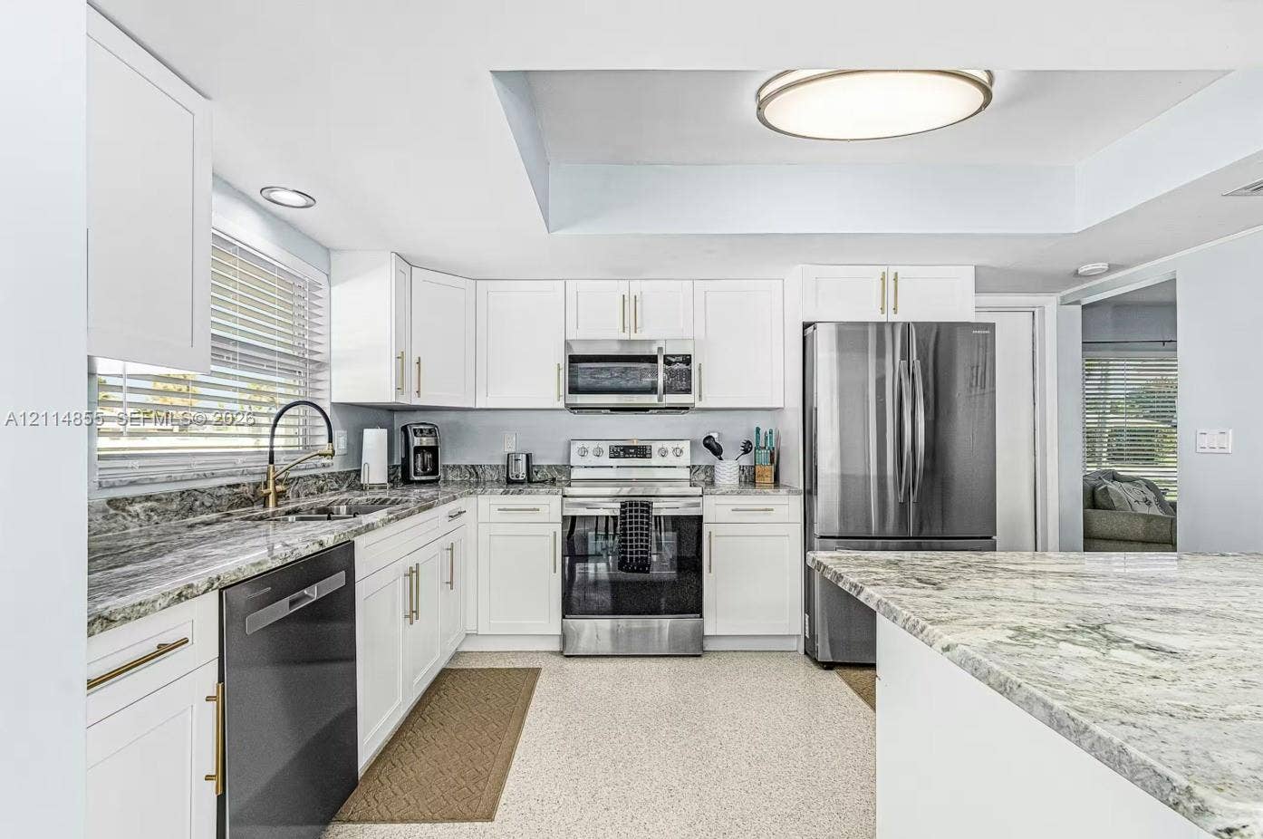 802 Montclair Court, Cape Coral, FL 33904 Kitchen featuring white cabinetry, stone countertops, stainless steel appliances, a high-arc faucet, and recessed ceiling lighting