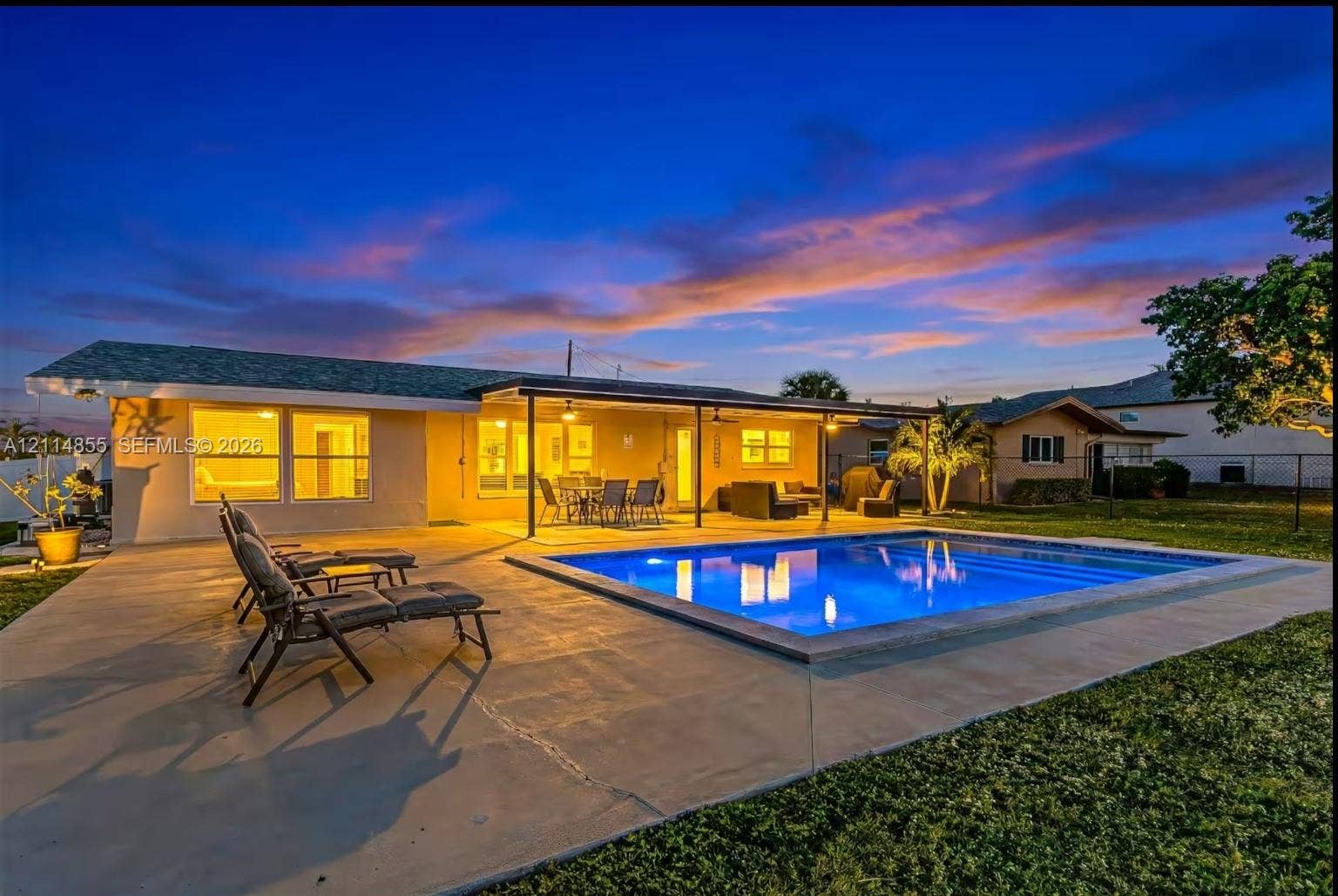 802 Montclair Court, Cape Coral, FL 33904 In-ground swimming pool with concrete decking, covered patio, and landscaped lawn