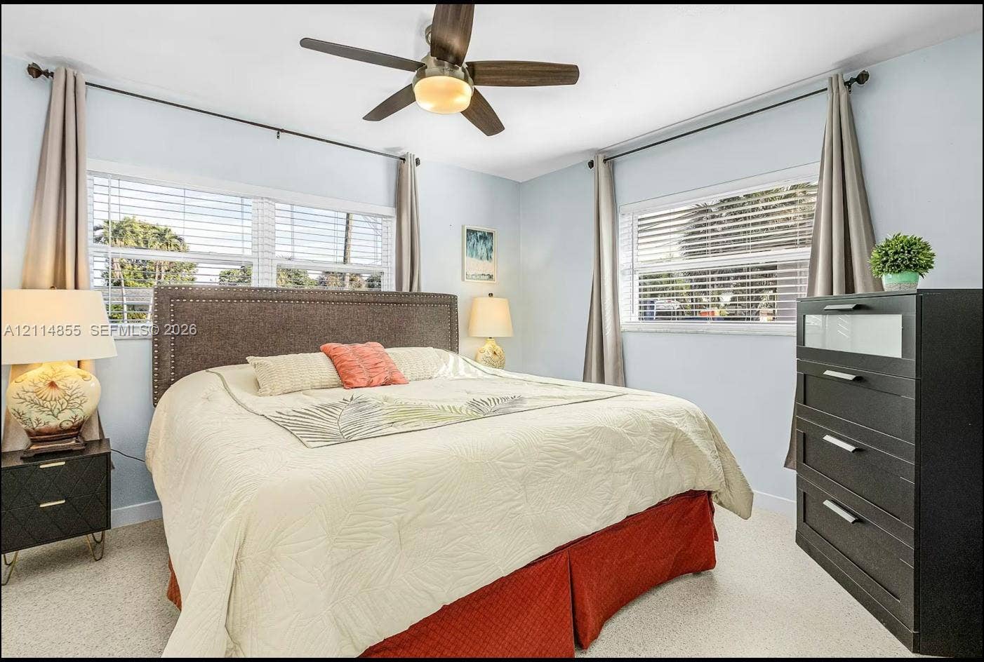 802 Montclair Court, Cape Coral, FL 33904 Room featuring neutral-toned carpeting, multi-pane windows with horizontal blinds, and a ceiling-mounted fan with integrated lighting