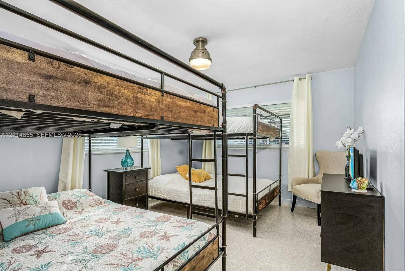 802 Montclair Court, Cape Coral, FL 33904 Neutral walls, horizontal window blinds, and overhead industrial-style flush mount lighting