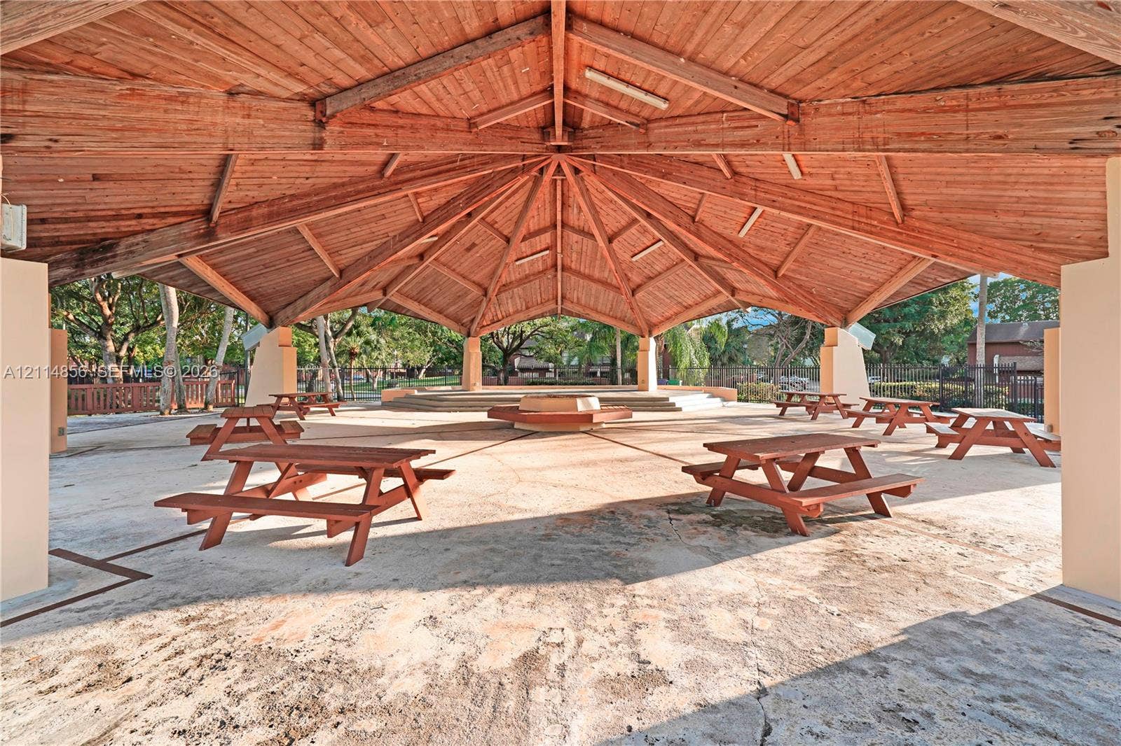Miami, FL 33173 Covered outdoor pavilion featuring a vaulted wood-beam ceiling, concrete flooring, and raised central platform