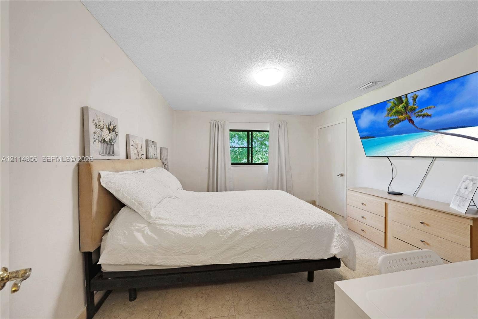 Miami, FL 33173 Bedroom featuring neutral walls, wall-to-wall carpeting, and a window with a black frame