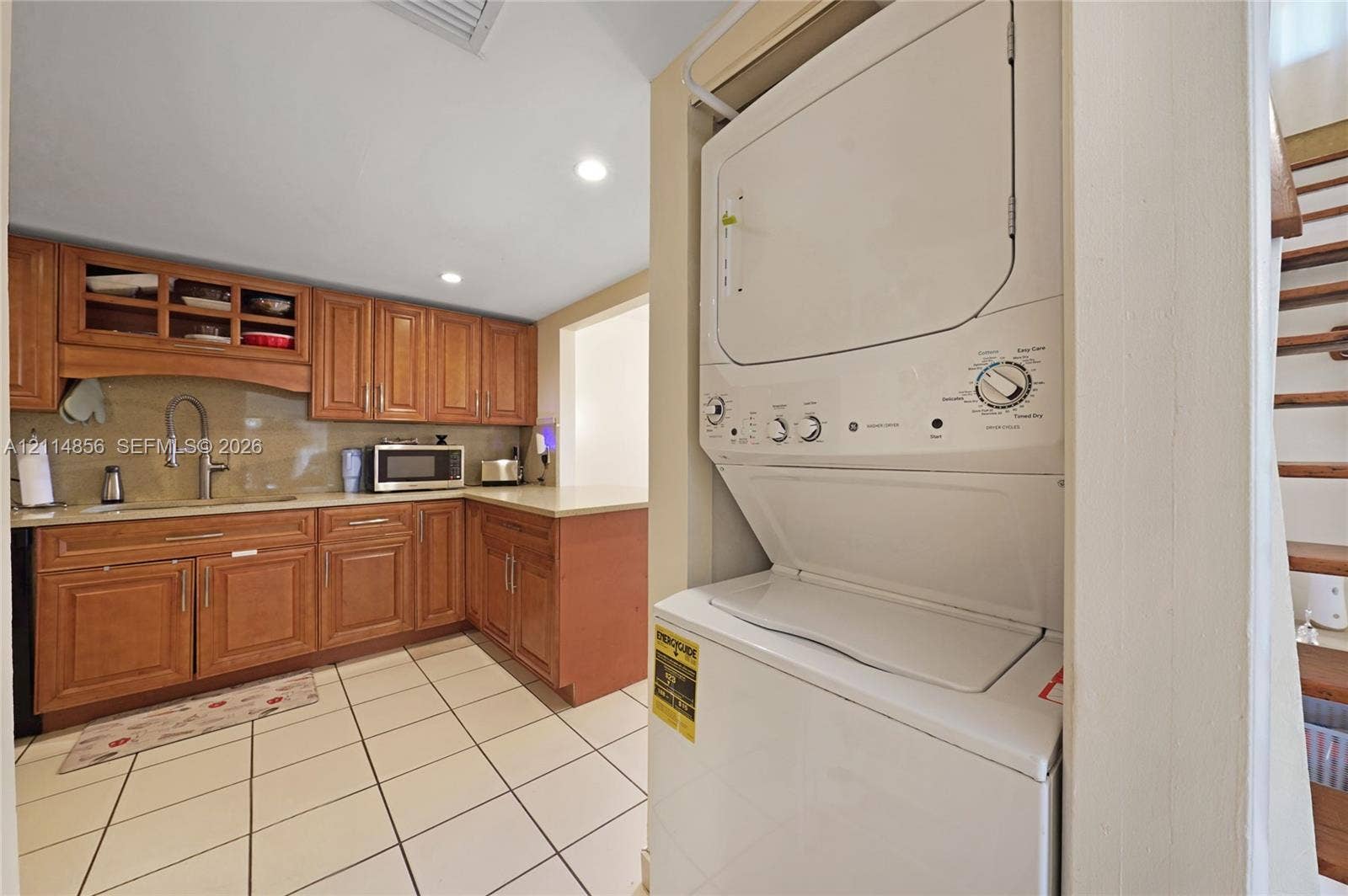 Miami, FL 33173 Kitchen featuring wood cabinetry, recessed lighting, tile flooring, and integrated laundry unit