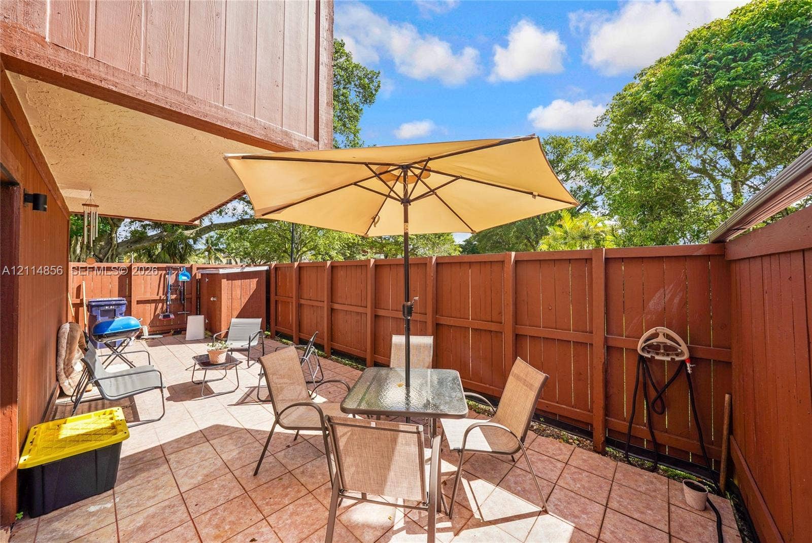 Miami, FL 33173 Private patio featuring tile flooring and wood-style privacy fencing